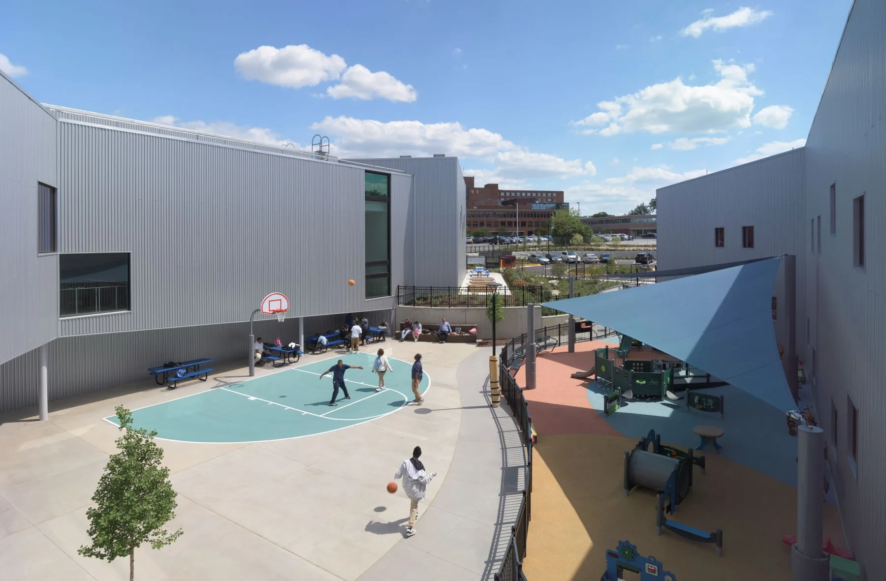 Conway Education Center outdoors play area with children playing in the basketball court.