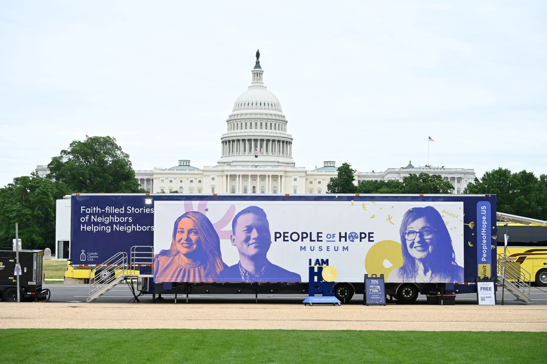 The 53-foot semi-tractor trailer truck with the words People of Hope Museum on it alongside images of three people smiling sits in front of the Capitol building in Washington, D.C.