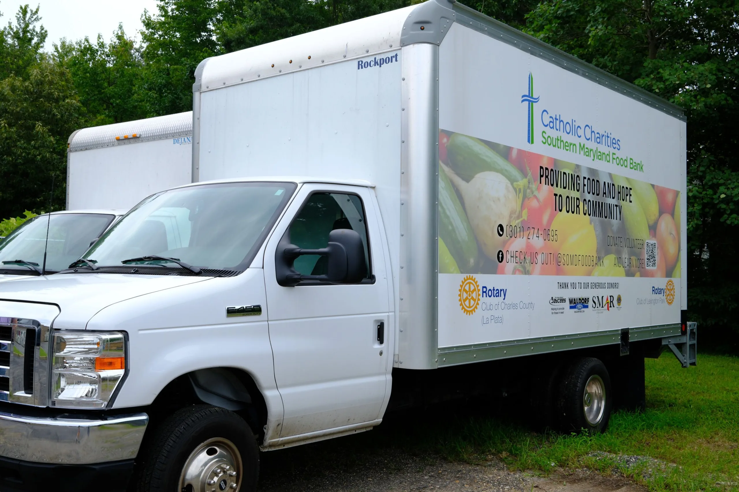 White Southern Maryland Food Bank Meals and Hope food truck parked on grass.